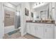 Clean bathroom with a vanity, shower with curtain, and decorative art at 8338 Modiano St, Orlando, FL 32827