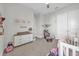 Bright ' bedroom with playful decorations, ceiling fan, and plush carpet at 8338 Modiano St, Orlando, FL 32827