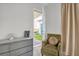 Cozy bedroom detail with muted decor, an olive chair, and a serene garden view at 8338 Modiano St, Orlando, FL 32827