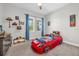 ' bedroom featuring race car themed bed, ceiling fan and two windows at 8338 Modiano St, Orlando, FL 32827