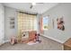 Cute ' bedroom with decorative light-up curtains and plush decor at 8338 Modiano St, Orlando, FL 32827
