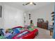 Bedroom with race car bed, dresser and plush carpet at 8338 Modiano St, Orlando, FL 32827