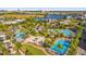 Aerial view of community amenities including pools, volleyball court, and serene lakeside setting for leisure activities at 8338 Modiano St, Orlando, FL 32827
