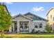 Charming home with a welcoming front porch, stone accents, and well-maintained landscaping at 8338 Modiano St, Orlando, FL 32827