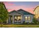 Charming single-Gathering home features a covered porch with stylish seating and a well-manicured lawn at 8338 Modiano St, Orlando, FL 32827