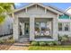 Charming front porch with stylish seating, decorative plants, and a welcoming entrance at 8338 Modiano St, Orlando, FL 32827