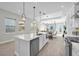 Modern kitchen featuring an open layout, large island with seating, and hardwood floors throughout at 8338 Modiano St, Orlando, FL 32827
