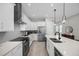 Contemporary kitchen featuring stainless steel appliances, white countertops, and stylish pendant lighting over an island at 8338 Modiano St, Orlando, FL 32827