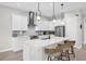Bright, modern kitchen with white cabinets, stainless steel appliances, and a spacious island with seating at 8338 Modiano St, Orlando, FL 32827