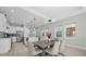 Modern kitchen and dining area with stainless steel appliances and stylish lighting fixtures at 8338 Modiano St, Orlando, FL 32827
