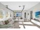 Bright living room featuring a comfortable sectional sofa and a glass garage door at 8338 Modiano St, Orlando, FL 32827