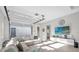 Bright living room featuring a comfortable sectional sofa and a glass garage door at 8338 Modiano St, Orlando, FL 32827
