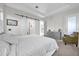 Comfortable main bedroom featuring tray ceiling, plush carpet, and sliding barn doors at 8338 Modiano St, Orlando, FL 32827