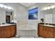 Bright bathroom features a garden tub, dual sinks, and ample counter space at 932 Emerald Green Ct, Kissimmee, FL 34746