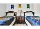 Bedroom with two twin beds and decorative banners on the wall at 932 Emerald Green Ct, Kissimmee, FL 34746