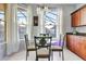 Cozy breakfast nook with a round table, bright windows, and view of the fenced backyard at 932 Emerald Green Ct, Kissimmee, FL 34746