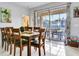Elegant dining room with a large table, modern lighting, and sliding glass doors to outdoor space at 932 Emerald Green Ct, Kissimmee, FL 34746