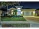 An elegant home with a well-manicured lawn and lush landscaping at 932 Emerald Green Ct, Kissimmee, FL 34746