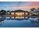 Exterior view of the building from the pool, surrounded by lush greenery at sunset at 932 Emerald Green Ct, Kissimmee, FL 34746