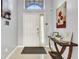 Bright foyer featuring tile flooring, high ceilings, and stylish decor, including a console table at 932 Emerald Green Ct, Kissimmee, FL 34746