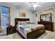 Comfortable bedroom boasts a ceiling fan, floral curtains, and stylish furnishings at 932 Emerald Green Ct, Kissimmee, FL 34746
