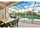 Covered patio with a view of the fenced pool and backyard at 932 Emerald Green Ct, Kissimmee, FL 34746