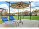 Outdoor patio with two lounge chairs at 932 Emerald Green Ct, Kissimmee, FL 34746