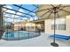 A beautiful screened-in pool and lounge area that is perfect for relaxing on a sunny day at 932 Emerald Green Ct, Kissimmee, FL 34746