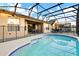 A gorgeous screened-in pool and backyard area offers a perfect space to relax at 932 Emerald Green Ct, Kissimmee, FL 34746