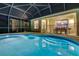 A gorgeous screened-in pool and backyard area with outdoor dining and room for relaxing at night at 932 Emerald Green Ct, Kissimmee, FL 34746
