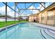 An inviting screened-in pool with clear water and relaxing area at 932 Emerald Green Ct, Kissimmee, FL 34746