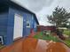 This home offers a patio area with outdoor seating, a fenced in yard, and blue exterior paint at 1617 Emmett St, Kissimmee, FL 34741