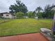 Expansive backyard with a chain-link fence, grass, small trees, and storage shed at 1617 Emmett St, Kissimmee, FL 34741