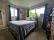Cozy bedroom featuring neutral walls, carpet flooring, and natural light from two windows with blue curtains at 1617 Emmett St, Kissimmee, FL 34741