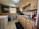 This kitchen provides cabinet space, appliances, and tiled flooring at 1617 Emmett St, Kissimmee, FL 34741