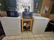 Laundry area with appliances, storage, and natural light in a bright and tiled room at 1617 Emmett St, Kissimmee, FL 34741