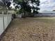 Backyard with lush green space, partial wooden fencing, and ample room for outdoor recreation at 527 Stillwater Dr, Oviedo, FL 32765