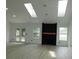 Spacious living room featuring skylights, a fireplace, and double doors at 527 Stillwater Dr, Oviedo, FL 32765