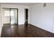 Cozy bedroom featuring rich hardwood floors, white walls, and access to an en-suite bathroom at 10330 Turkey Lake Rd # A-4 Ak/A 107, Orlando, FL 32819