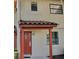 Charming townhome exterior featuring an arched doorway, tiled roof, and neutral stucco at 10330 Turkey Lake Rd # A-4 Ak/A 107, Orlando, FL 32819