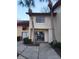 Inviting townhouse exterior featuring lush palm trees and a tiled roof, near a paved walkway at 10330 Turkey Lake Rd # A-4 Ak/A 107, Orlando, FL 32819