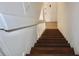 Carpeted staircase with wooden steps, white railings, and a view of the front door at 10330 Turkey Lake Rd # A-4 Ak/A 107, Orlando, FL 32819