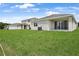 Picturesque backyard with a well-maintained lawn and views of neighboring residences at 1126 Olivine Ave, Dundee, FL 33838