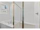 A stylish bathroom featuring a soaking tub with chrome fixtures and a glass-enclosed shower at 1126 Olivine Ave, Dundee, FL 33838