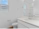 Clean, bright bathroom with white vanity, modern fixtures, and a shower/tub combo at 1126 Olivine Ave, Dundee, FL 33838
