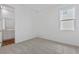 Well-lit bedroom with a connecting bathroom, neutral carpet, and a window offering outside views at 1126 Olivine Ave, Dundee, FL 33838