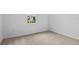 Neutral bedroom with carpet flooring and a bright window overlooking a tree at 1126 Olivine Ave, Dundee, FL 33838