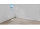Neutral bedroom with carpet flooring and a bright window overlooking a tree at 1126 Olivine Ave, Dundee, FL 33838