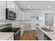 Modern kitchen featuring white cabinets, stainless steel appliances, and an island at 1126 Olivine Ave, Dundee, FL 33838