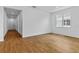 Bright living room featuring stylish wood-look floors and a large window at 1126 Olivine Ave, Dundee, FL 33838